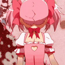 a girl in a pink dress has a heart cut out in the back of her apron