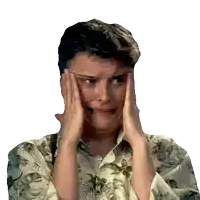 a man covering his face with his hands and a floral shirt