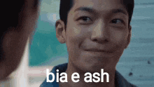 a man is smiling with the words bia e ash on his face .