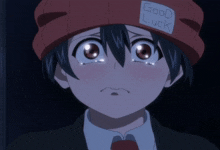 a boy wearing a red hat with the words good luck on it