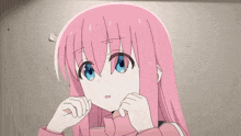 a girl with pink hair and blue eyes is holding a condom in her hand