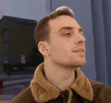 a man in a brown jacket with a fur collar