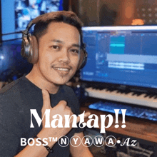 a man wearing headphones is sitting in front of a computer with the words mantap boss nyawa az below him