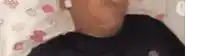 a close up of a person 's face laying on a bed with a pillow .