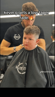 kevin g gets a low taper fade while getting his hair cut