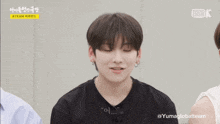 a young man in a black shirt says well in a video