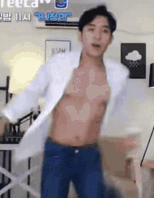 a man without a shirt is dancing in a room .