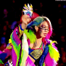 a woman in a colorful outfit is standing next to another woman in a colorful outfit .