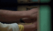 a man is holding a child 's hand while they are playing with a toy .