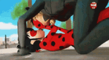 a ladybug and cat noir are kissing in a cartoon scene .