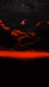 a man wearing a black shirt with a crescent moon on it sits in a pool