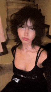 the girl is wearing a black dress and a choker necklace .