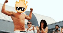 a shirtless man flexes his muscles with a flaming head and sunglasses on