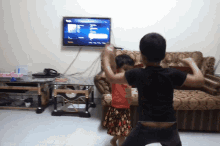 a boy and a girl are dancing in front of a flat screen tv that says ' netflix ' on it