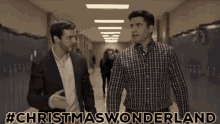 two men walking down a hallway with the words #christmas wonderland written on the bottom