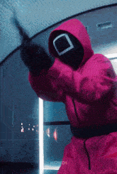 a person in a pink suit is holding a knife and the word howdi is on the bottom of the image