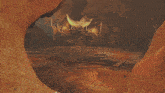 a computer generated image of a cave with a man standing in front of the entrance
