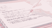 a person is writing in a notebook with a pencil