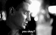 a black and white photo of a man asking if he is ok
