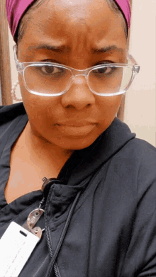 a woman wearing glasses and a name tag that says " nurse " on it
