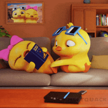 two cartoon ducks are sitting on a couch and one is reading a book called duck quack