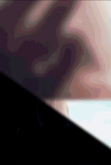a blurred image of a person 's face with a black background