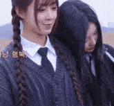 two girls are standing next to each other with korean writing on the bottom