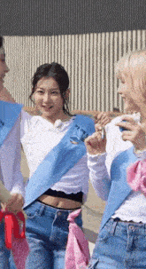 a group of young women are standing next to each other .