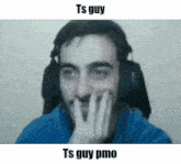 a man wearing headphones is making a funny face with his hand on his face .