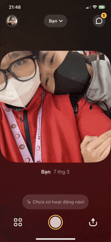 a phone screen shows a couple wearing face masks and glasses