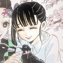 a girl is holding a black bird with a pink bow on it