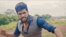 a man with a beard is standing in a field .