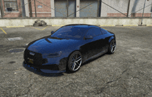 a black audi car is parked in a parking lot with a brick building in the background