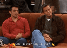 two men are sitting on a couch and one is saying well played