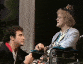 a woman in a wheelchair is being held by a man