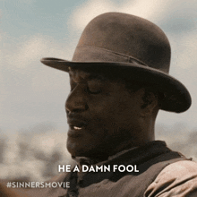 a man wearing a hat says he a damn fool on the bottom