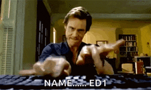 a man is typing on a computer keyboard while pointing at the camera .