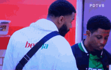 a man wearing a white hoodie that says beja on the back