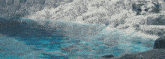 a large body of water surrounded by snow and ice