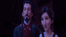 a man and a woman are standing next to each other in a dark room and looking at each other .