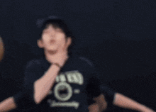 a group of young men are dancing in a dark room and one of them has a shirt that says arctic fox