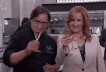 a man and a woman are toasting with champagne glasses in a restaurant .