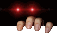 a person 's fingers are sticking out of a hole in a dark room with red lights behind them