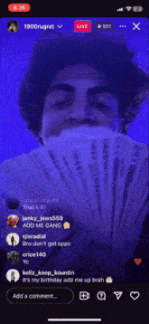 a man is holding a bunch of money in front of his face in a live video