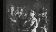 a black and white photo of people dancing in a club