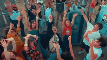 a group of people dancing in front of a sign that says danger voltage