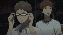 a man wearing glasses is standing next to another man in a white shirt