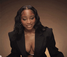 a woman wearing a very plunging black jacket