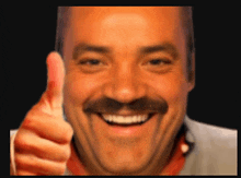 a man with a mustache is smiling and giving a thumbs up sign
