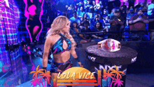 a woman in a bikini is standing in front of a lola vice sign